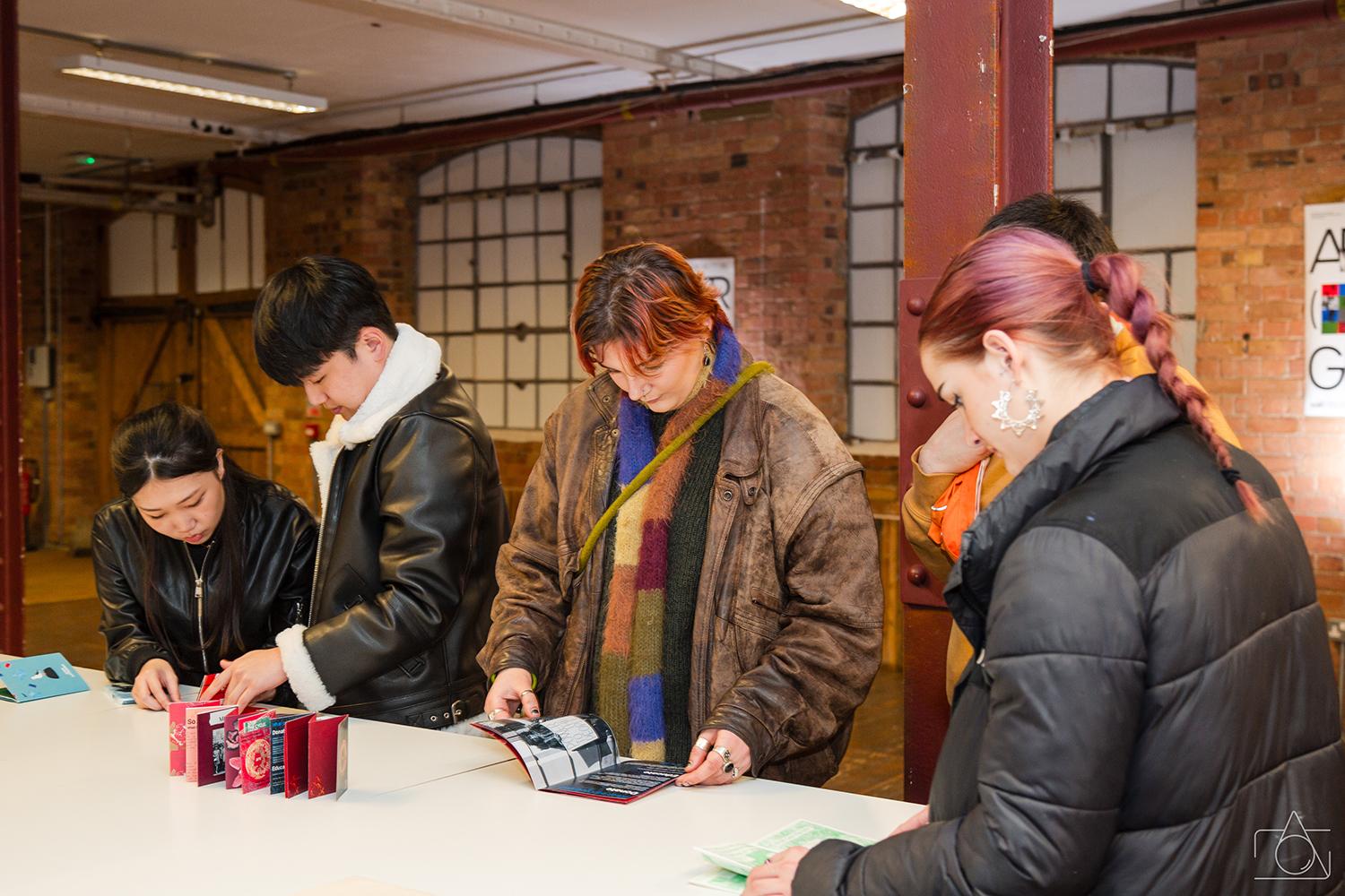 Visitors looking at zines