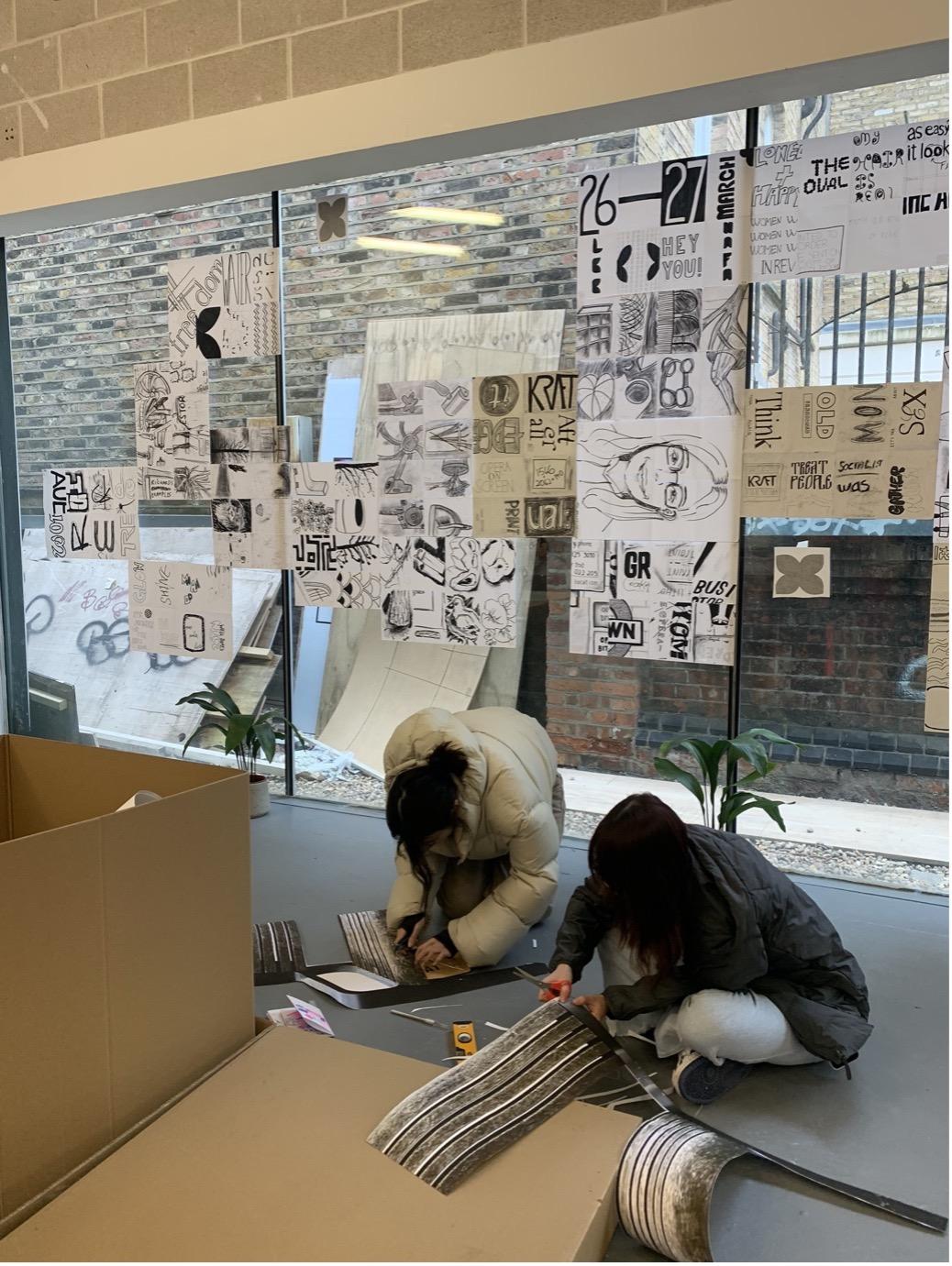 2 students busy assembling work for the exhibition