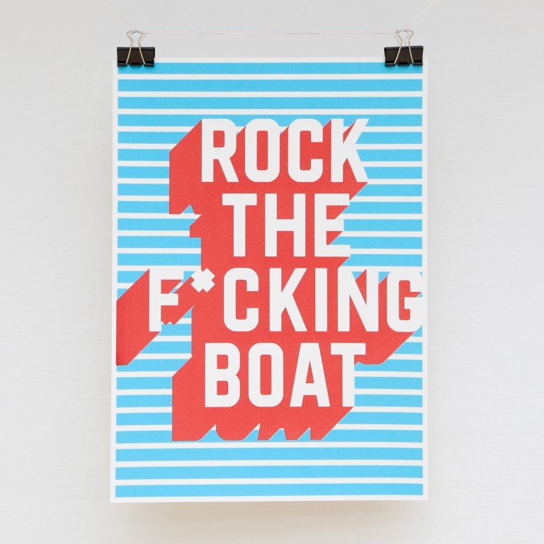 The words "rock the f*cking boat" written in white text with a red shadow on top of a light blue and white horizontally striped background