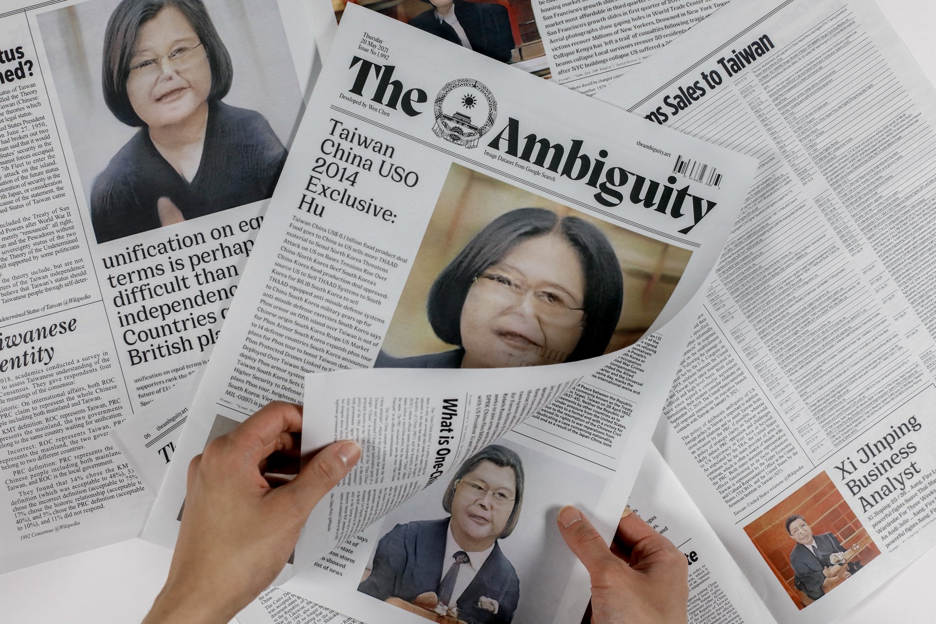 Printed Copy of The Ambiguity Newspaper. Hand model: Jacob Chueng.