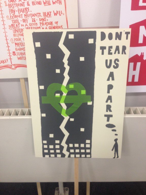 A protest poster about the Grenfell building fire reading "Don't Tear Us Apart"